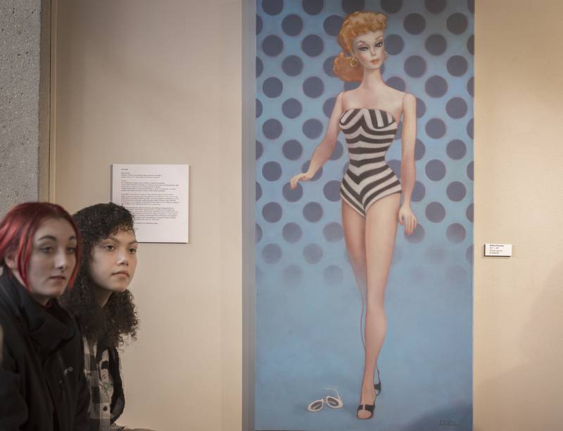 Sauk Valley Community College art students Rayne Pyron, left, of Rock Falls and Christina Chattic of Sterling listen as artist Deborah Di Vita Glascott discusses her pieces on display Monday, March 20, 2023 during the closing of her show at the SVCC art gallery.