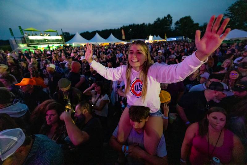Haleigh Angelico cheers during the opening concert from atop of the shoulders of Kyle Kutz at Streator Fest on August 1, 2025.