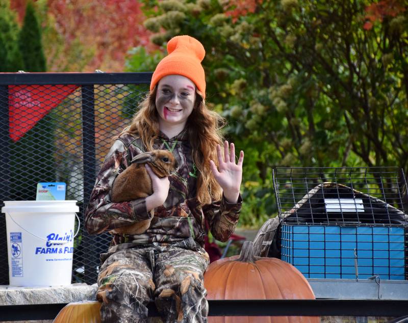 Shayna Altergott holds a rabbit named Fawn on the Blain's Farm & Fleet float during the Sycamore Pumpkin Festival, held Sunday, Oct. 31, 2021.