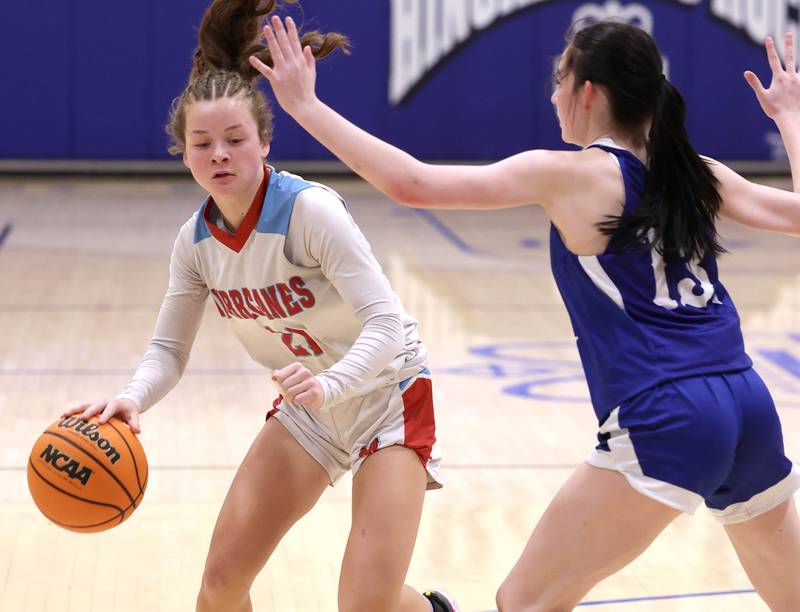 Marian Central's Lainey Remke drives against Hinckley-Big Rock's Mia Cotton Monday, Feb. 16, 2026, during their regional semifinal game at Hinckley-Big Rock High School.