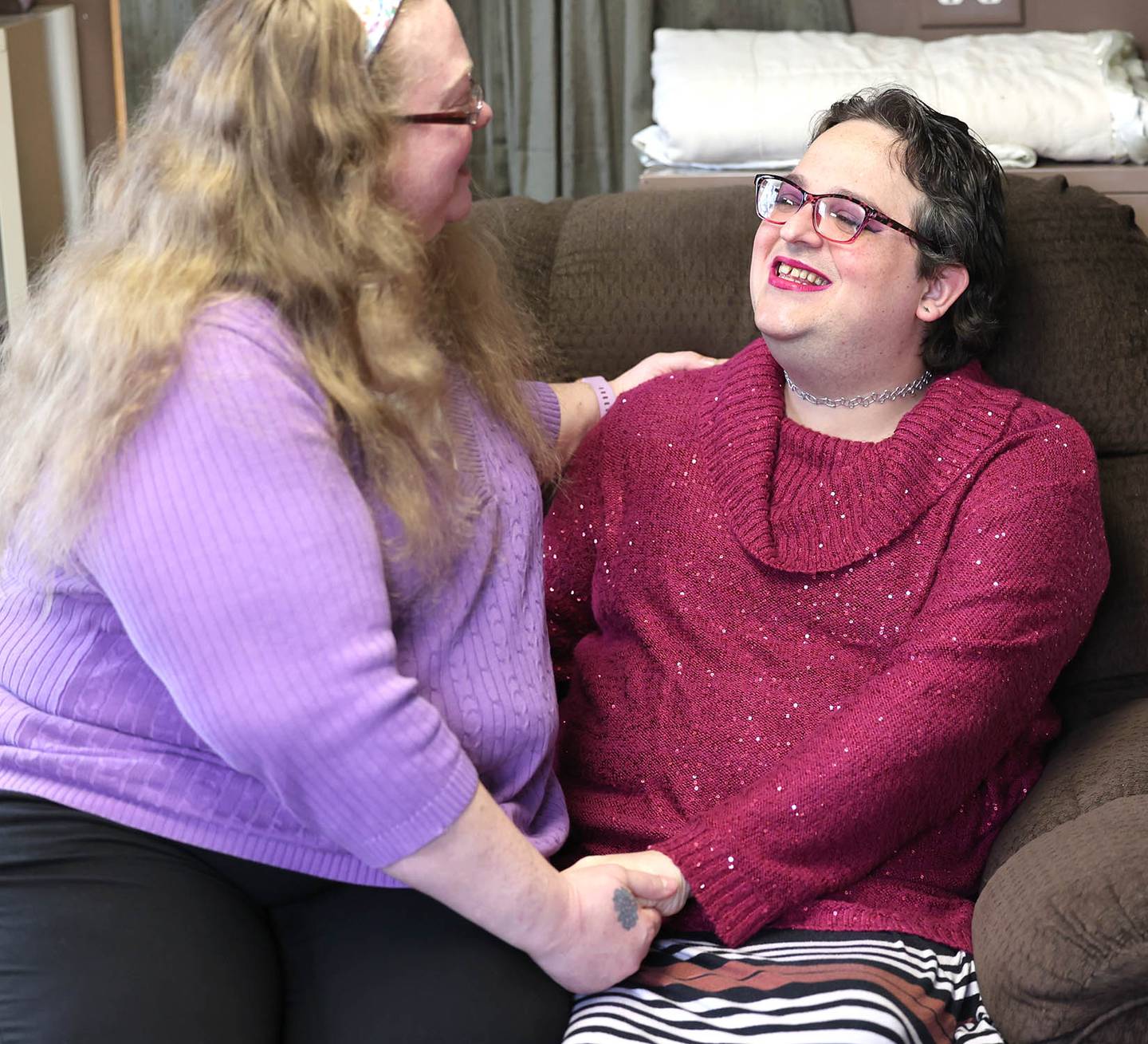 Elizabeth Fern Jensen (right) shares a laugh with fiancé Jamie Jensen Tuesday, Dec. 13, 2022, in their DeKalb home.
