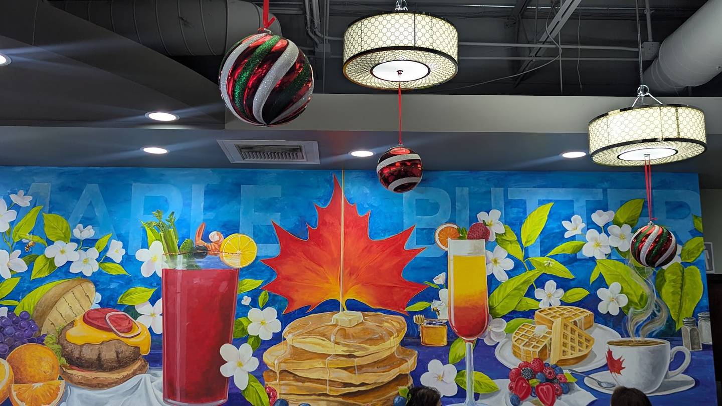 A mural especially designed for Maple Butter Cafe in Plainfield is seen on the back wall of the dining room on Monday, December 16, 2024.
