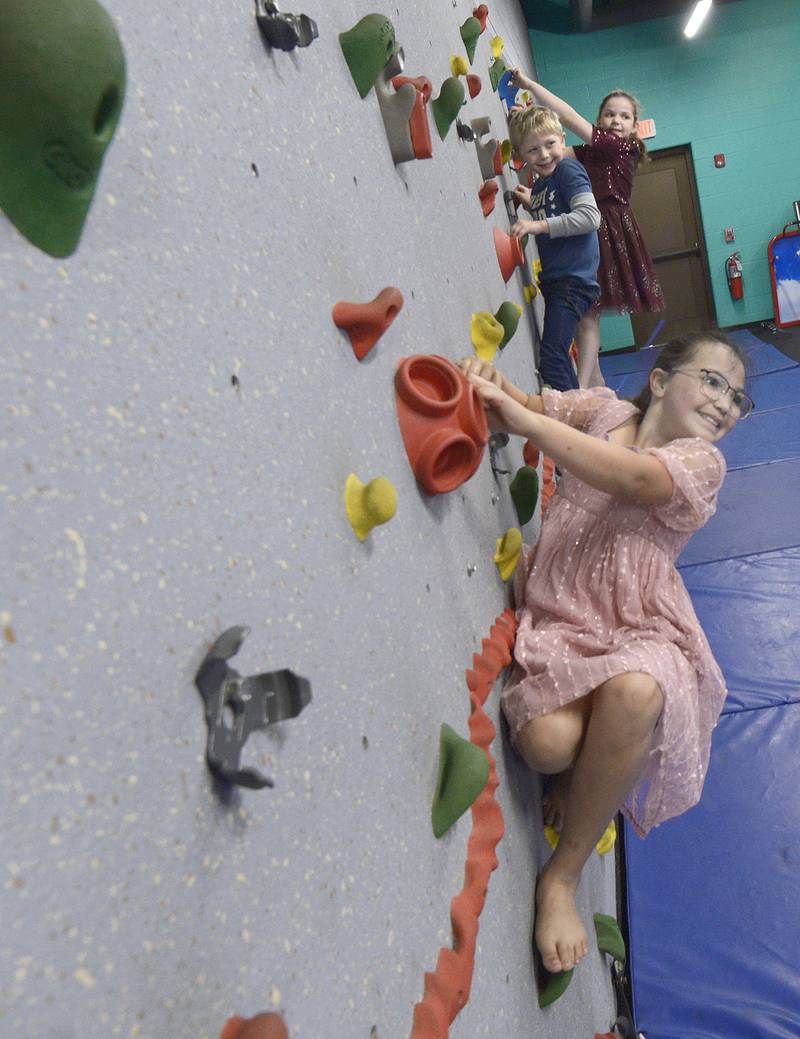 Annabella Hays shows how it’s done on the climbing wall Saturday, April 20, 2024, during the Healthy Kids Day at the Streator Y.