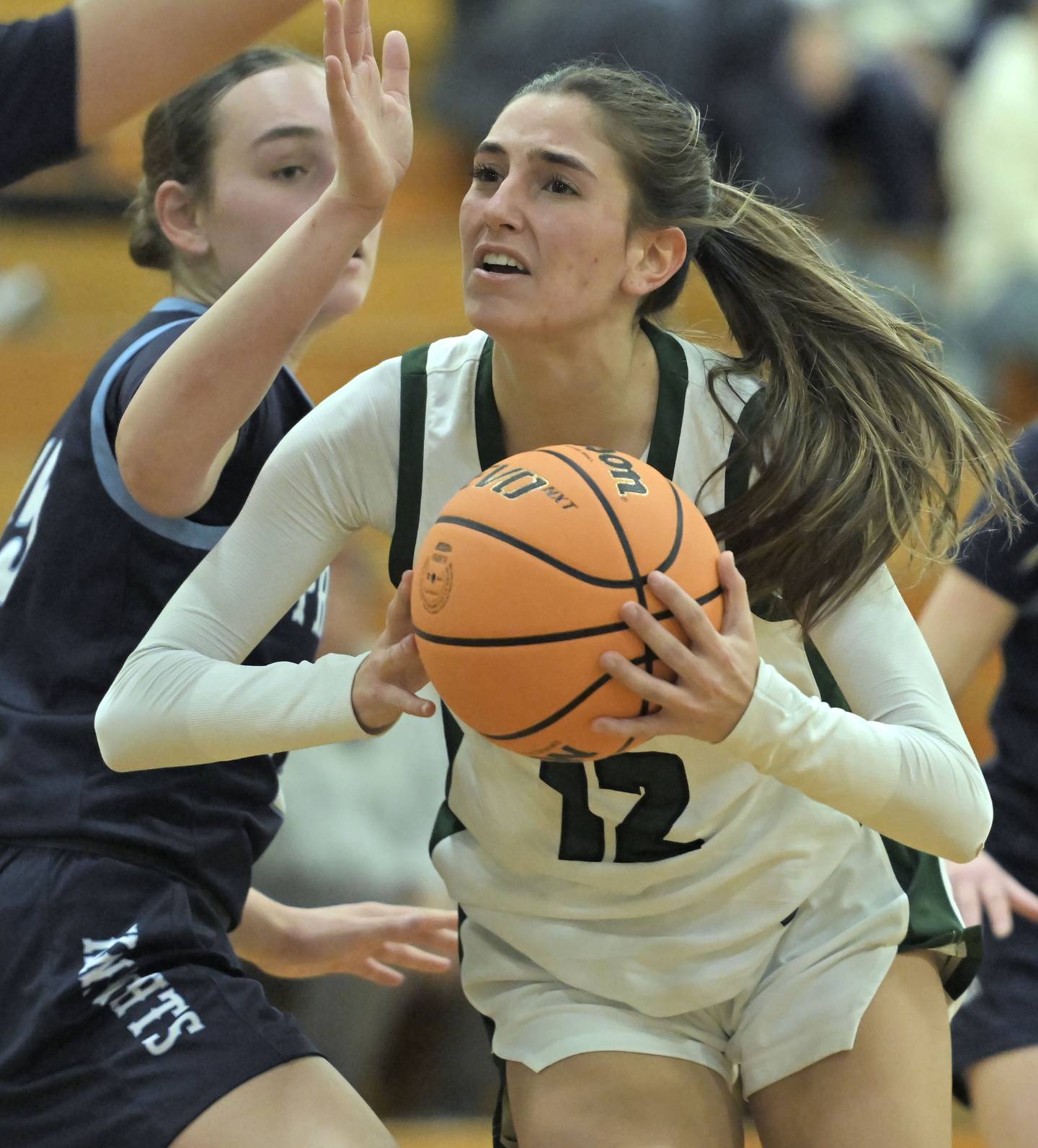 Glenbard West’s Hannah Roberts spins in the paint against Prospect’s Zoe Black in a girls basketball game in Glen Ellyn on Thursday, Jan. 9, 2025.
