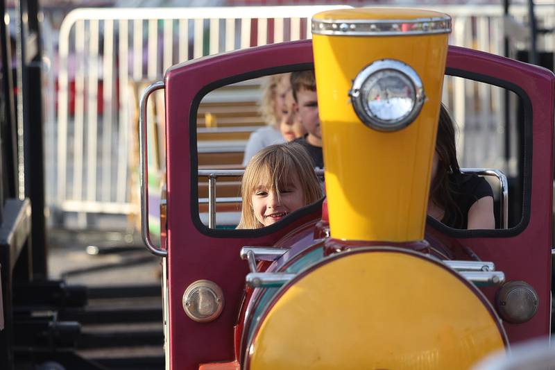 Harper Huguley, 4, smiles while riding the train at Old Canal Days on Friday June 7, 2024 in Lockport.