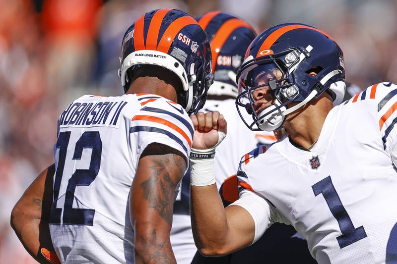 Chicago Bears quarterback Justin Fields (1) talks to wide receiver Allen Robinson (12) during the first half of an NFL football game against the Green Bay Packers, Sunday, Oct. 17, 2021, in Chicago.