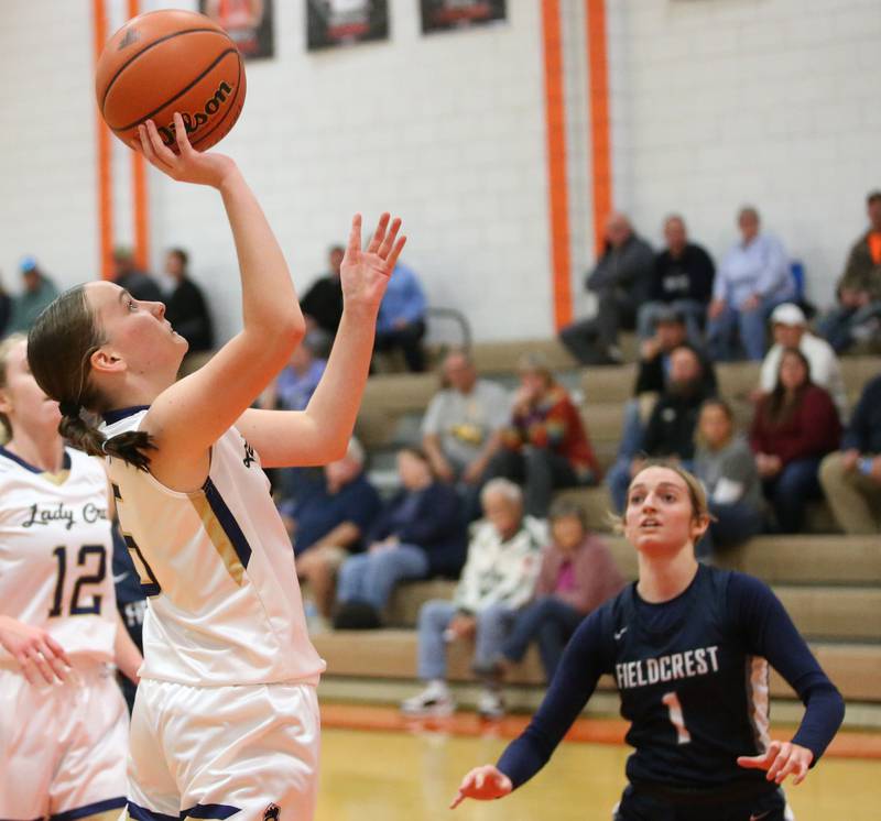 Marquette's Chloe Larson pulls up in the lane to score a basket over Fieldcrest's Kaitlyn White during the Integrated Seed Lady falcon Basketball Classic tournament on Monday, Nov. 13, 2023 at Flanagan High School.