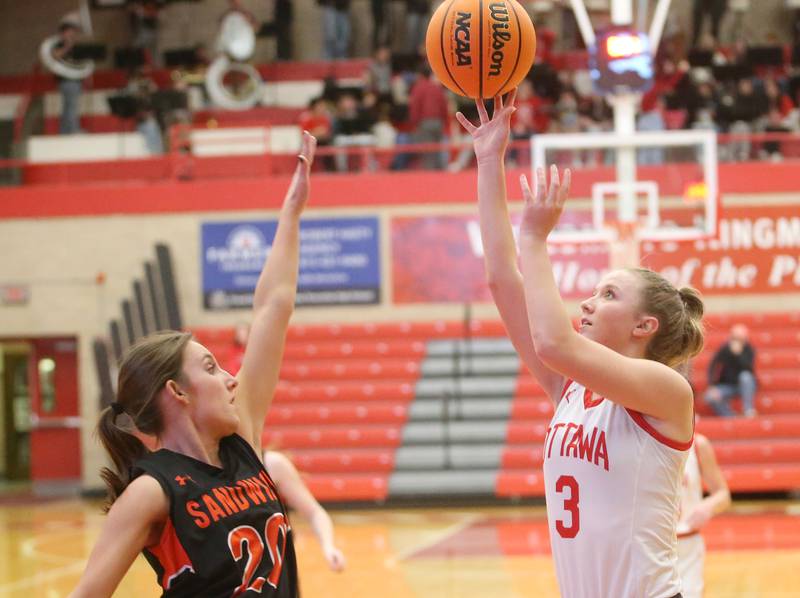 Ottawa's Skylar Dorsey lets go of a shot over Sandwich's Mia Geltz on Monday, Jan. 27, 2025 in Kingman Gym at Ottawa High School.