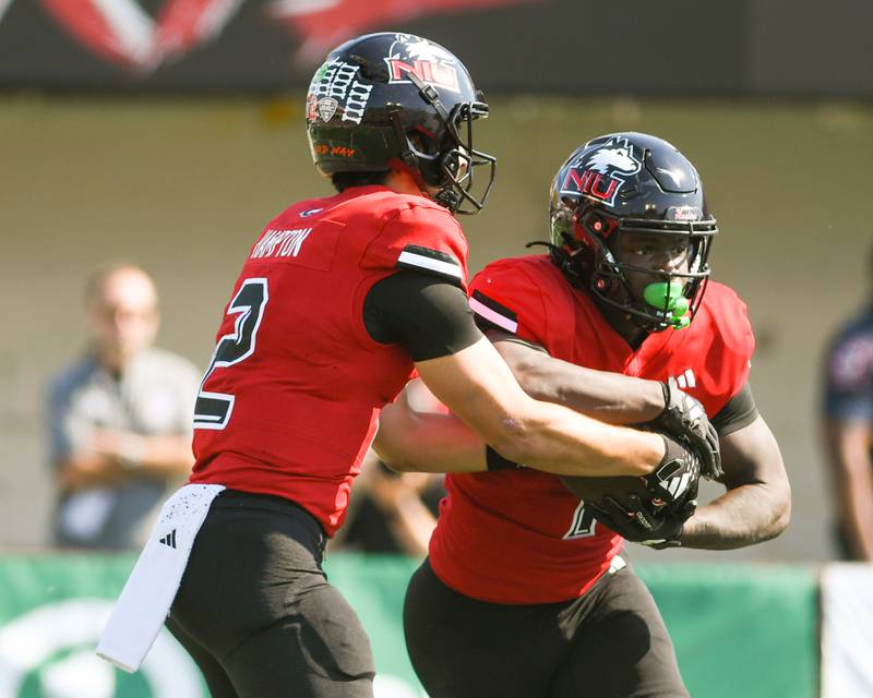 Northern Illinois Huskies quarterback Ethan Hampton, left, hands the ball off to Northern Illinois Huskies running back Antario Brown during the game against UMass on Saturday Oct. 5, 2024, held at Huskie Stadium in DeKalb.