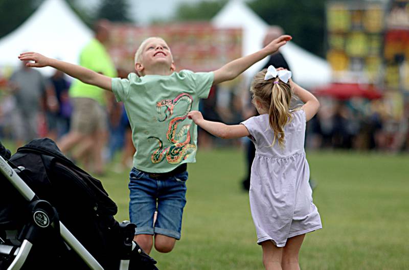 Finn Sahs, left, 6, dances with his sister Violet, 3, during the Rockin’ Rib Fest Friday at Sunset Park in Lake in the Hills.