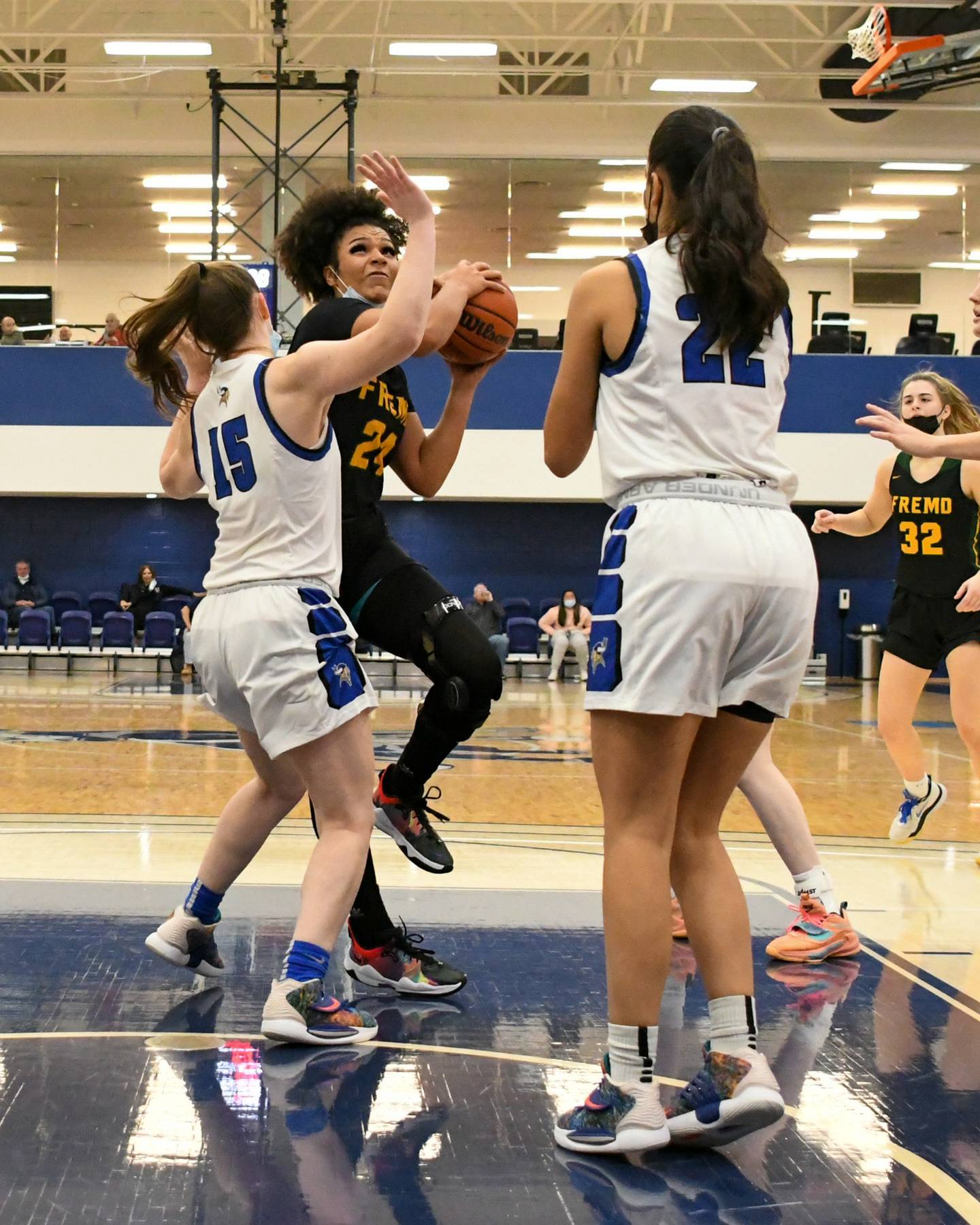 Fremd Brianna Wooldrige (24) makes a basket in the second quarter while being defended by Geneva Cassidy Arni (15) on Thursday Dec. 30th during the championship game at Morton College in Cicero.
