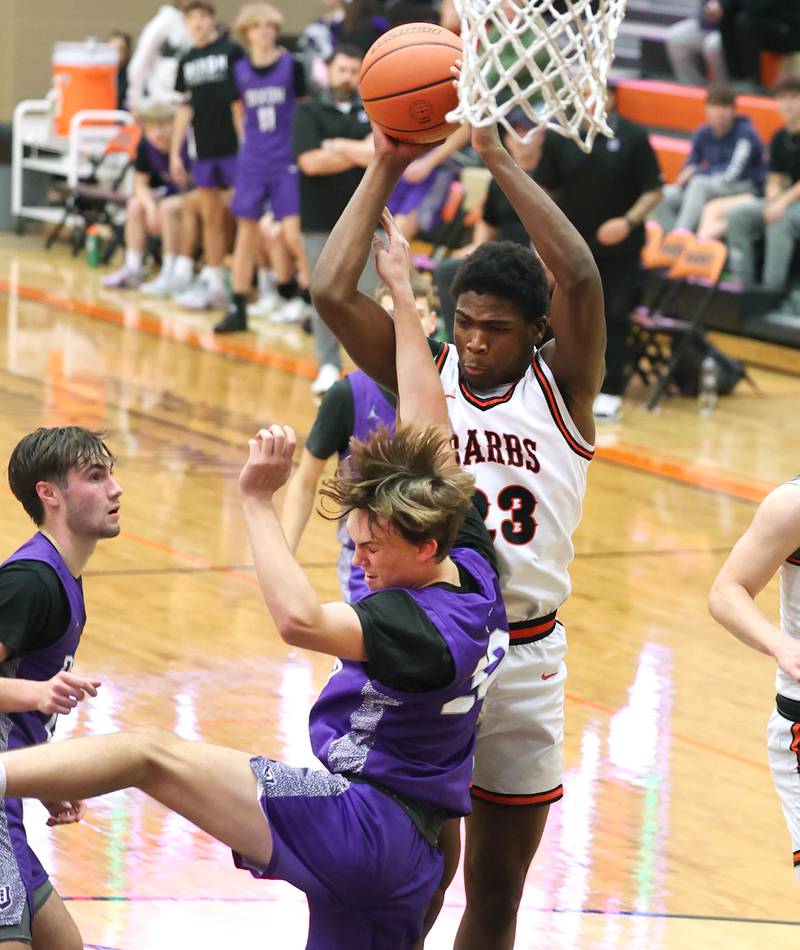 DeKalb’s Davon Grant grabs a rebound over Dixon’s Bryce Feit during their game Tuesday, Dec. 12, 2023, at DeKalb High School.