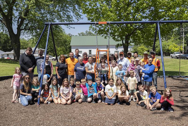 Family, friends, Dixon Park District employees and the St. Mary’s third grade class gather around “Sophia’s Swing” Friday, May 15, 2026.