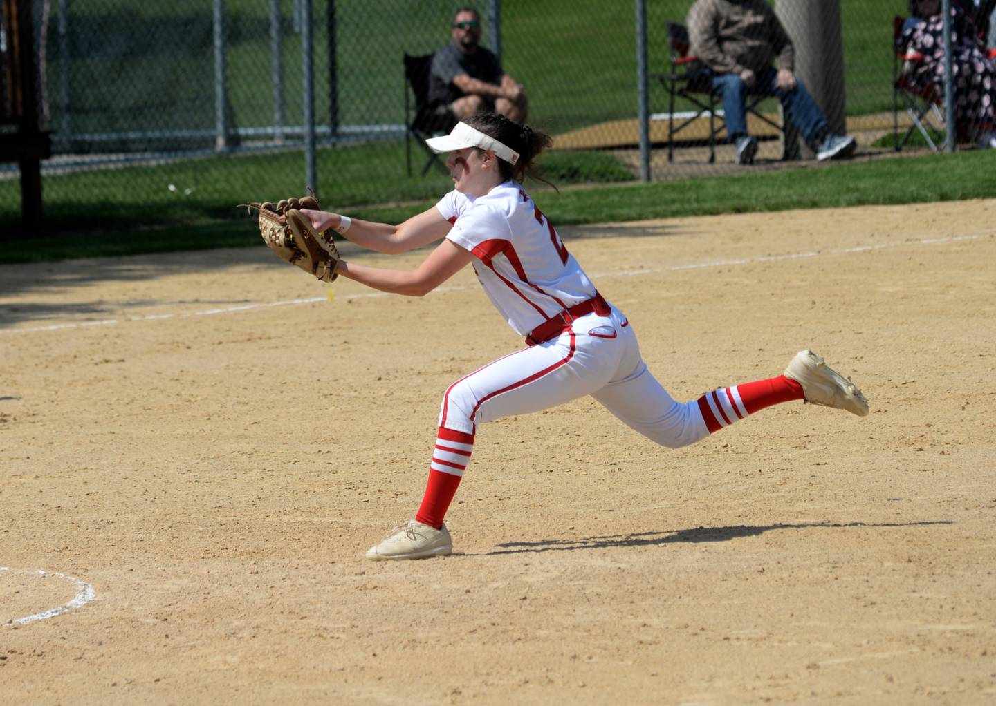 Oregon's Reilee Suter stretches to catch a fly ball for an out against Marengo during the championship of the 2A Oregon Regional on Saturday, May 20. The Hawks lost the game 8-3.