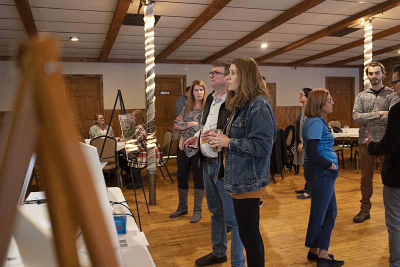 Andy and Angela Shaw of Dixon look over some of the plans for the redevelopment of the Sterling riverfront Wednesday, April 5, 2023. The Sterling Riverfront Commission shared renderings and ideas with the public during an event at Champs Banquet Facility.
