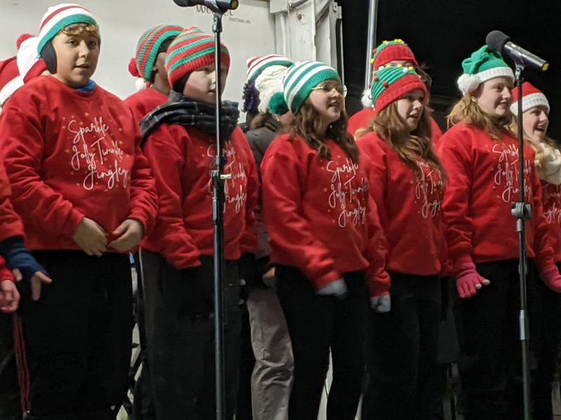 The Traughber Junior High School Chorus sing the song “Sparkle Jolly Twinkle Jingly” from “Elf The Musical” during the Oswego Christmas Walk on Dec. 6.
