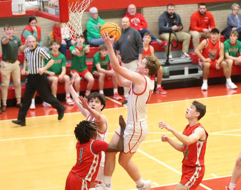 Ottawa's Evan Snook runs in the lane to score over L-P's Cordell Wheatley on Friday, Jan. 10, 2024 in Kingman Gym at Ottawa High School.