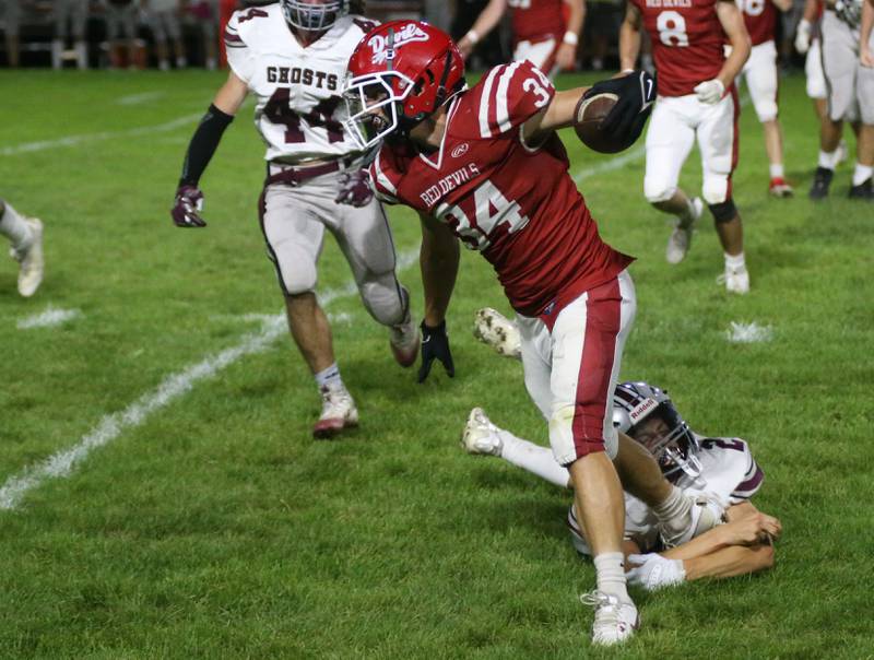 Hall's Aiden Redcliff runs past Illinois Valley Central's Mason Marchand on Friday, Sept. 29, 2023 at Richard Nesti Stadium.