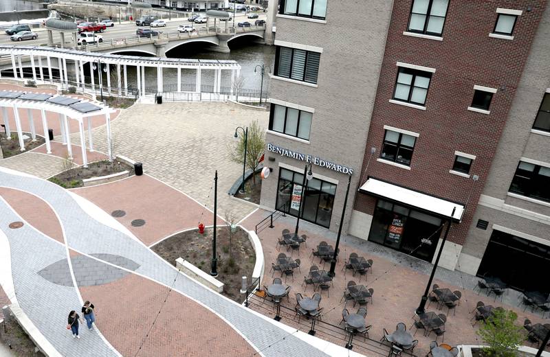Pedestrians stroll in the closed section of First Street in St. Charles.