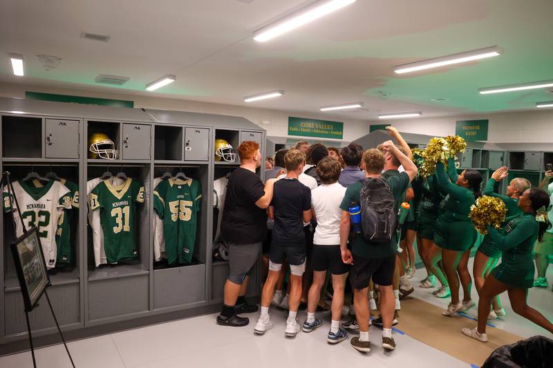 Bishop McNamara football players and cheerleaders excitedly sing the school fight song for the first time in the new locker room at Bishop McNamara's new Rich Zinanni Athletic Complex during the ribbon-cutting ceremony on Thursday, Aug. 21, 2025.