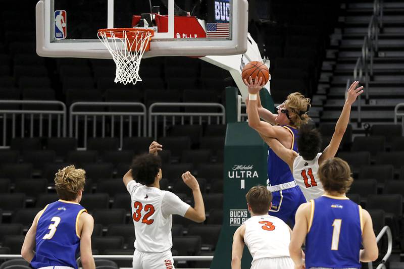 Johnsburg's lan Boal drives to the basket against McHenry's Hayden Stone during a non-conference basketball game Sunday, Nov. 27, 2022, between Johnsburg and McHenry at Fiserv Forum in Milwaukee.