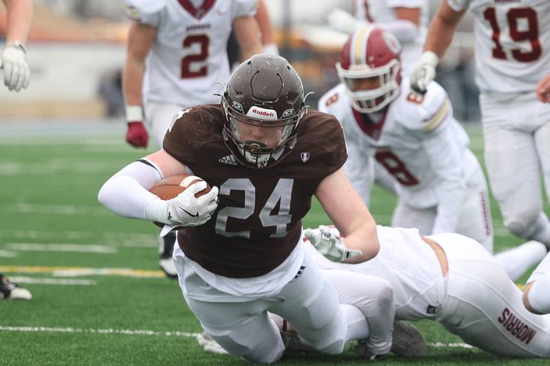 Joliet Catholic’s Larry Stringham drops forward for a first down run against Morris in the Class 5A semifinal on Saturday, Nov. 23, 2024.
