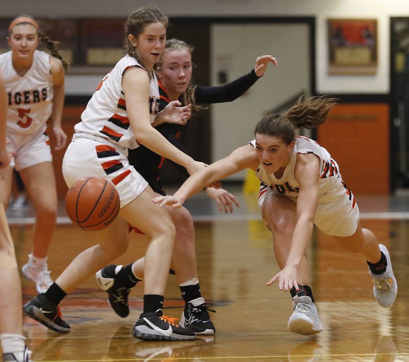 Crystal Lake Central's Kathryn Hamill, right, dives after a loose ball in front of her teammate, Ella Madalinski,, left, and McHenry's Emerson Gasmann, center, during a Fox Valley Conference girls basketball game Tuesday, Nov.. 29, 2022, between Crystal Lake Central and McHenry at Crystal Lake Central High School.