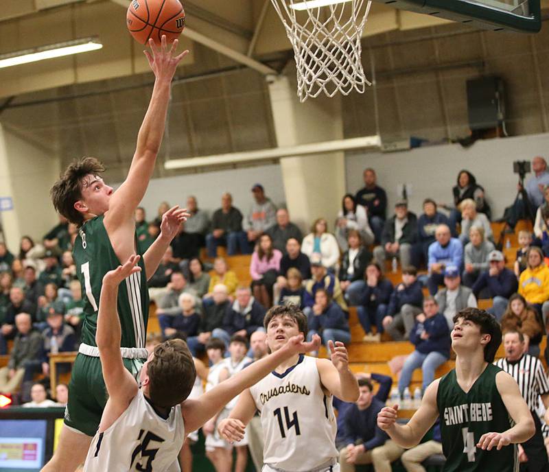 St. Bede's Connor Brown draws an offensive foul on Marquette's Tommy Durdan in the Class 1A Regional semifinal on Wednesday, Feb. 22, 2023 at Midland High School.