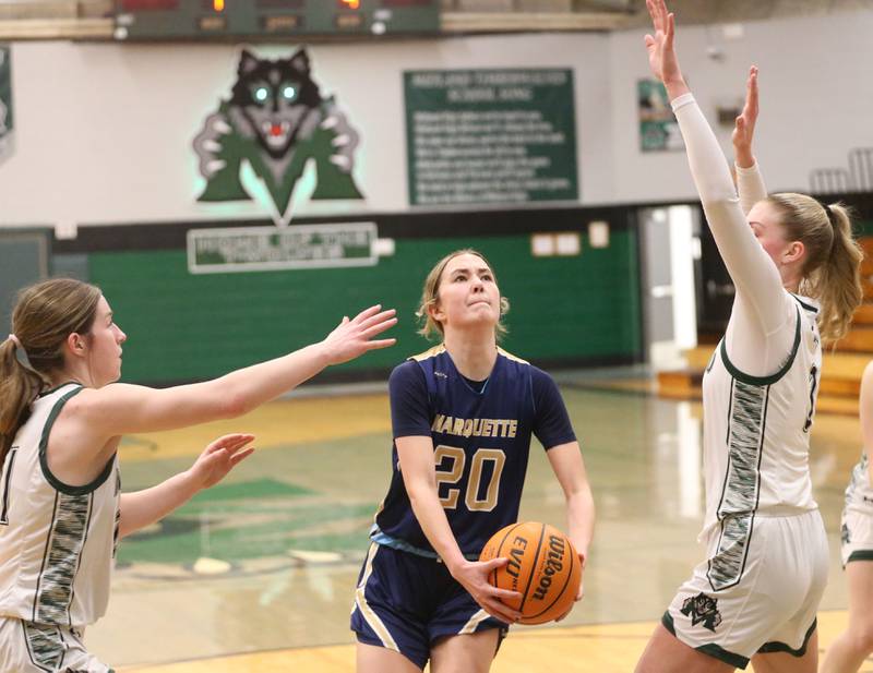 Marquette's Kaitlyn Davis cuts into the lane to score against Midland's Adalyn Stickle and Anna McGlasson on Thursday, Feb. 12, 2026 at Midland High School.