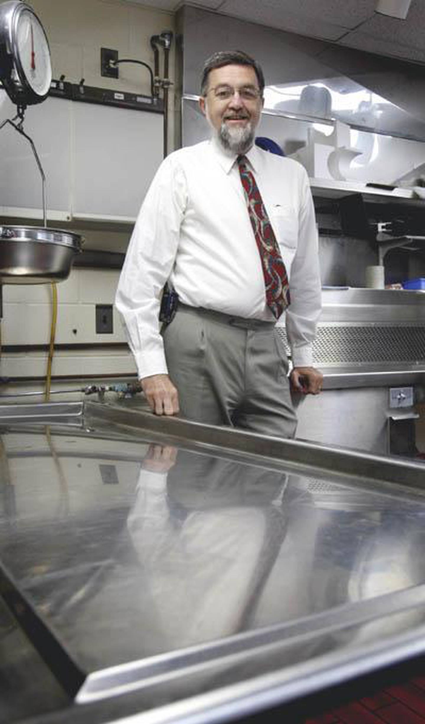 Dennis Miller stands in the county morgue in this Shaw Local file photo from March 22, 2012. Miller is the DeKalb County coroner and director of the county’s Emergency Services and Disaster Agency.