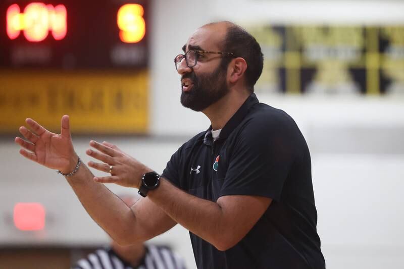 Plainfield East head coach Kanwer Sarkaria talks to a player during the game against Joliet West on Friday, Dec. 8th, 2023 in Joliet.