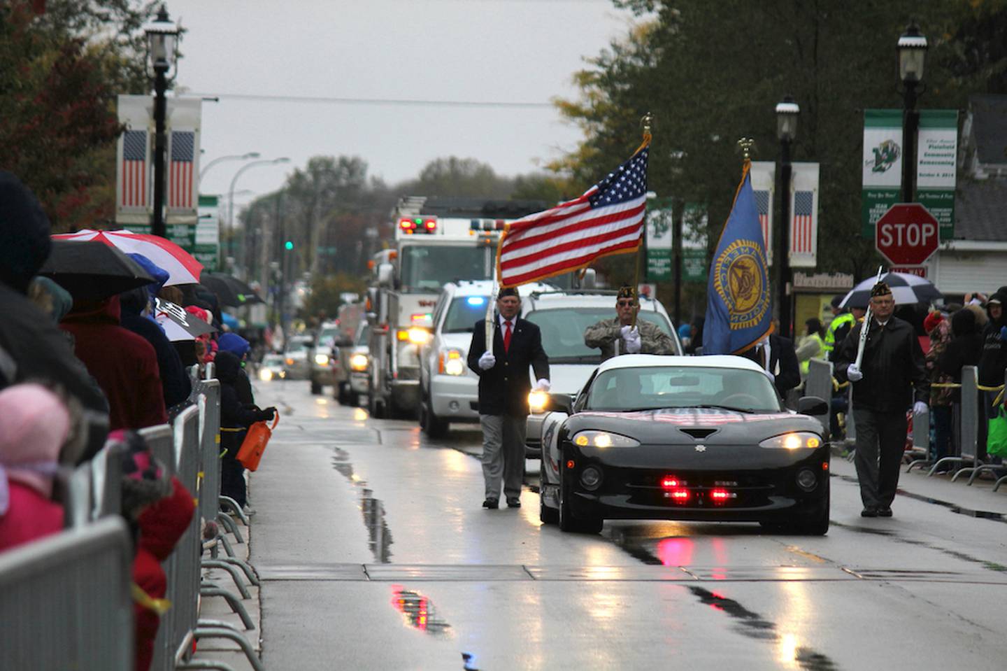 Despite 35 degree temperatures and a steady rain, a large crowd was on hand as the Plainfield American Legion Color Guard led off the 63rd Annual Plainfield Homecoming Parade on Saturday.
