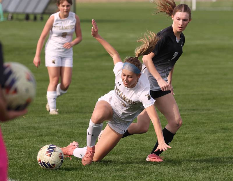 Sycamore's Marin Gautcher falls in front of Kaneland's Olivia Davis during their game Monday, April 13, 2026, at Kaneland High School.