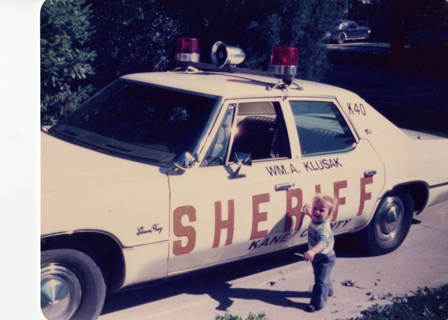 Shawn Barrows, 2, stands next to his father Dave Barrows' squad car in 1976. Shawn Barrows went on to join law enforcement in 1996 and retired Monday, June 3.