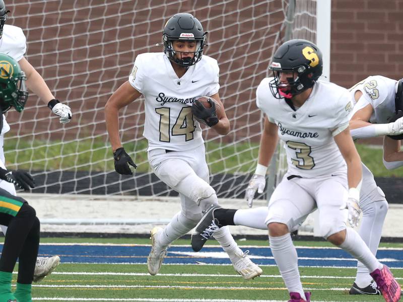Sycamore's Josiah Mitchell carries the ball through a hole in the Westinghouse line Saturday, Nov. 9, 2024 during their Class 5A second-round playoff game at Knute Rockne Stadium in Chicago.
