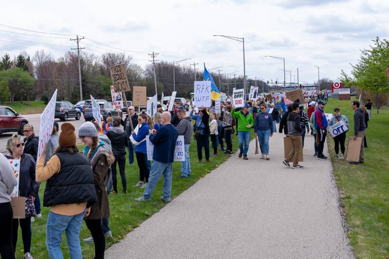Protesters hold up protest signs along Randall Road in South Elgin, IL to protest their issues with President Donald J. Trump and his administration and Elon Musk involvement in US government affairs on Saturday April 19, 2025. 
Hundreds of protesters participated in the latest Hands Off protest occurring in the Chicagoland area and the rest of the country.