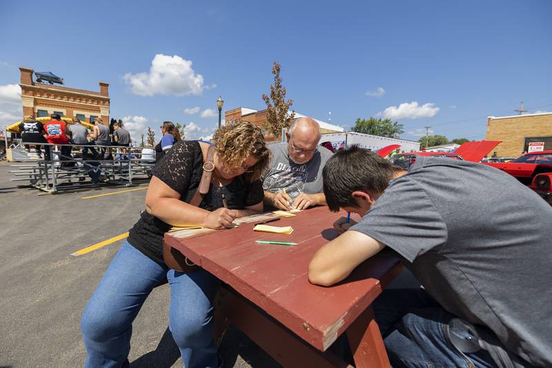 Lisa Kress with husband Robert and son Patrick Sweeny of Davis fill out 50/50 tickets Sunday, August 27, 2023. The Depot Days raffle is the hottest ticket in the area, handing out over $125,000 to a single winner. This year the winner was Angela Bowman of Sublette.