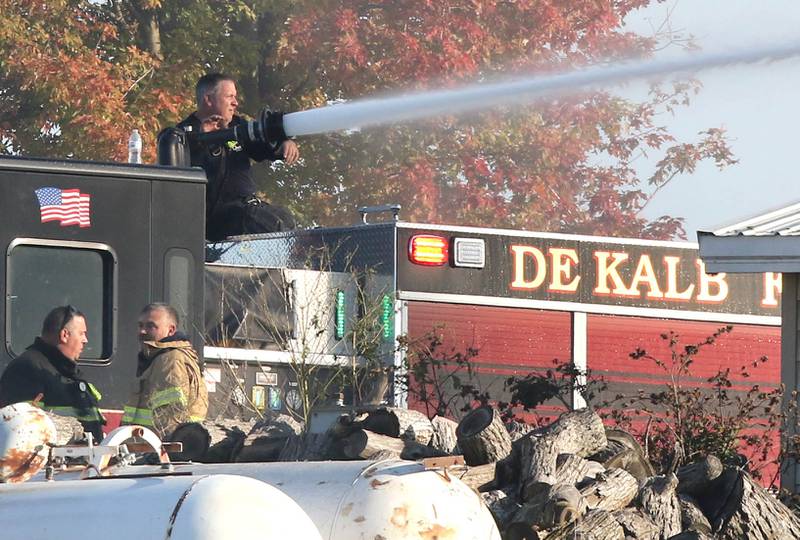 A DeKalb fire crew puts water on the smoldering remnants of a house Tuesday, Oct. 17, 2023, after an explosion at the residence on Goble Road in Earlville. Several fire departments responded to the incident at the single-family home that left one person hospitalized.