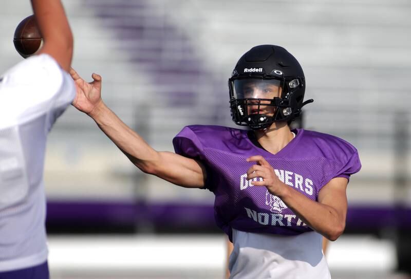 Downers Grove North quarterback Owen Lansu throws the ball during a practice at the school on Tuesday, Aug. 15, 2023.