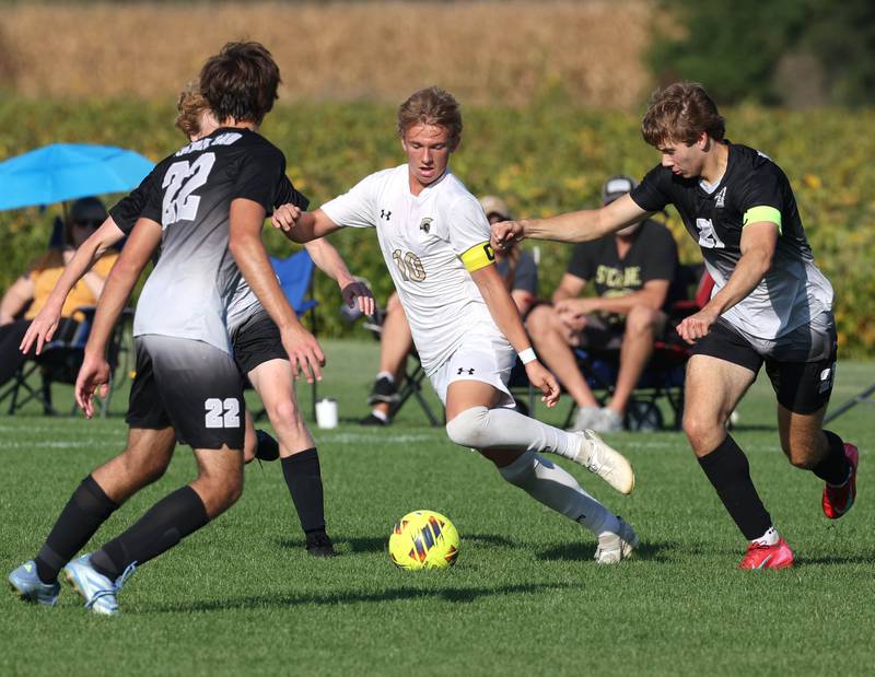 Sycamore's Gavin Crouch waeves his way through a host of Kaneland defenders during their game Wednesday, Sept. 16, 2025, at Kaneland High School in Maple Park.