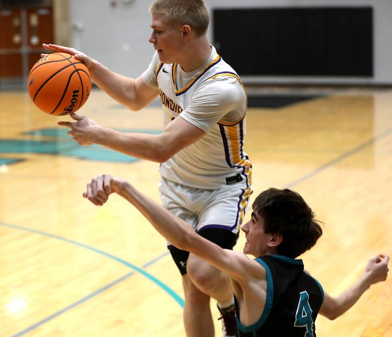 Woodstock North's Zaiden Vess (right) tries to knock the ball away from Hononegah's Brenden Tell during the 2025 Hoops for Healing tournament basketball game on Wednesday, Nov. 26, 2025, at Woodstock North High School.
