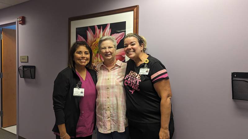 Annamae Ginter, 70, of Oak Forest (center)  was treated for two different breast cancers in one breast at Silver Cross Hospital in New Lenox, and is doing well. Ginter gives the credit for her good to her health care providers at Silver Cross Hospital in New Lenox, which recently received its 18th straight "A" from The Leapfrog Group for patient safety. Ginter is pictured on Friday, Oct. 6, 2023, with Lisa Senerchia, clinic nurse for oncologist Dr. Simona Cosmina Chivu (left) and Tracy Heinzman, patient coordinator at the breast surgery clinic.