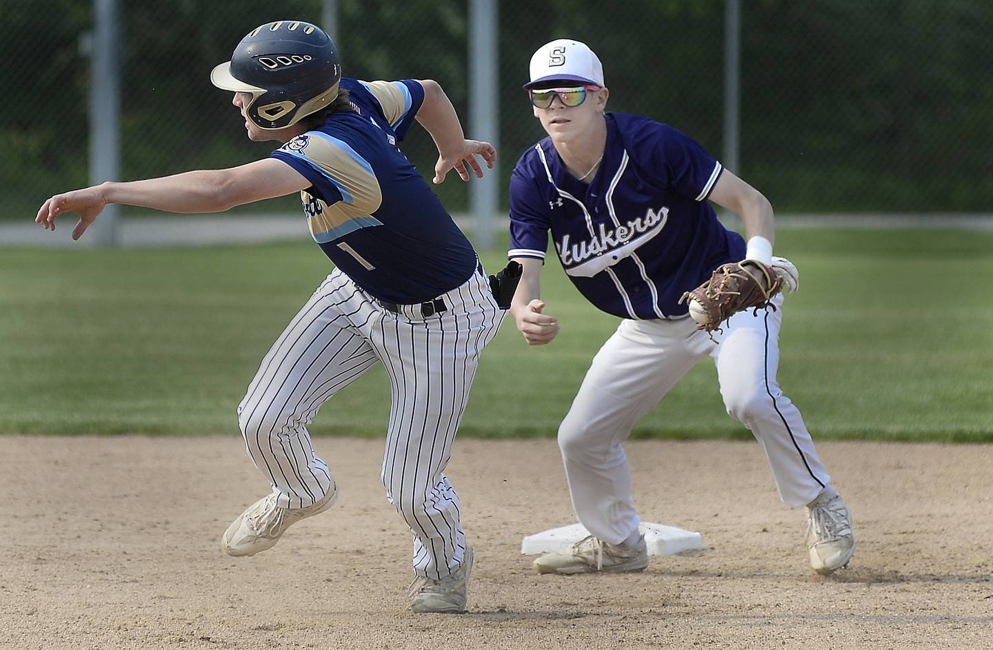 Serena’s Tanner Faivre chases Marquette’s Tommy Durdan during a run down in the1st inning Wednesday, May 17, 2023 at Marquette.