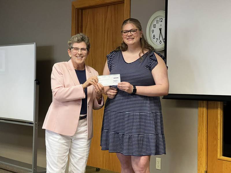 First Ward Alderperson Alicia Cosky presented 2024 Sycamore High School graduate Anna Aska with a $100 check for her work in designing a logo for the Sycamore beautification committee on Aug. 19, 2024.