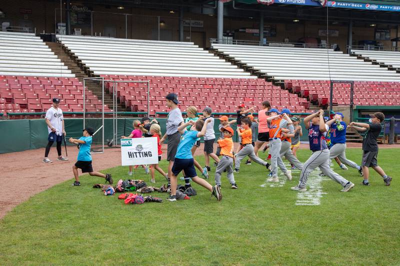 Kids practice hitting at the hitting station of the Kane County Cougar's Youth Clinic at Northwestern Medicine Field on Saturday, July 16, 2022.