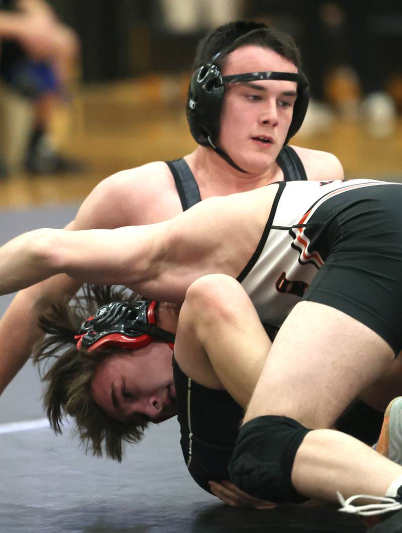 Sycamore’s Dylan Curtis (top) wrestles Kaneland’s Colton Heltsley at 157 pounds Thursday, Jan. 9, 2025, at Sycamore High School.