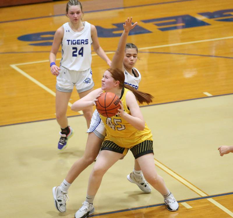 Putnam County's Emma Henderson dribbles in the lane while being guarded by Princeton's Reese Reviglio during the Princeton High School Lady Tigers Holiday Tournament on Thursday, Nov. 16, 2023 at Prouty Gym.