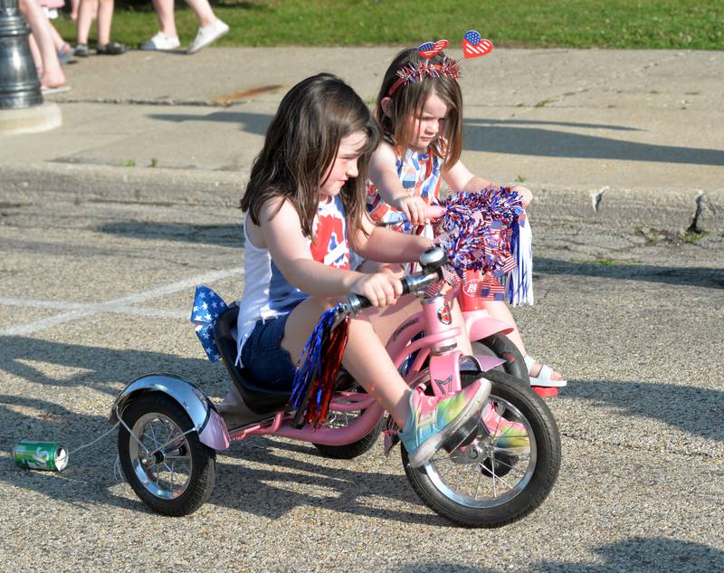 Bostyn abd Lenny Millard, ages 5 and 2, of Mt. Morris sit on their trikes at the Let Freedom Ring Kiddie Parade on Monday. Sixty one kids took part in the event.