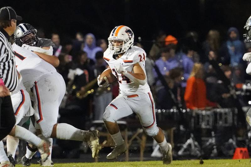 Oswego’s Ayden Villa (24) carries the ball against Oswego East during a football game at Oswego East High School on Friday, October 25, 2024.