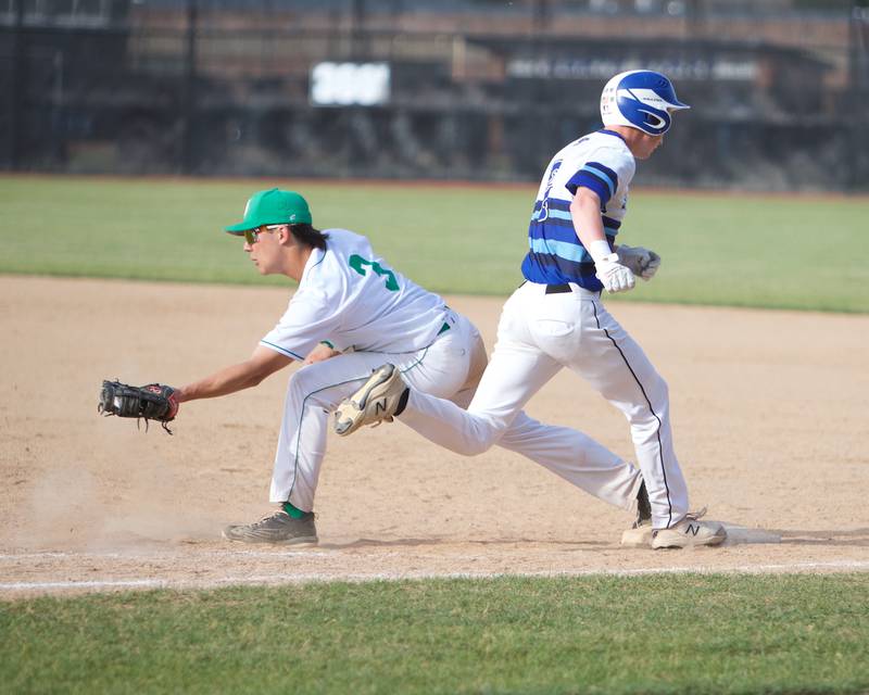 St. Charles North's Jack Spotts tries to beat the play at first aS York'sOwen Chael picks the throw at the Class 4A Sectional Final on Friday May 31, 2024 in St. Charles.